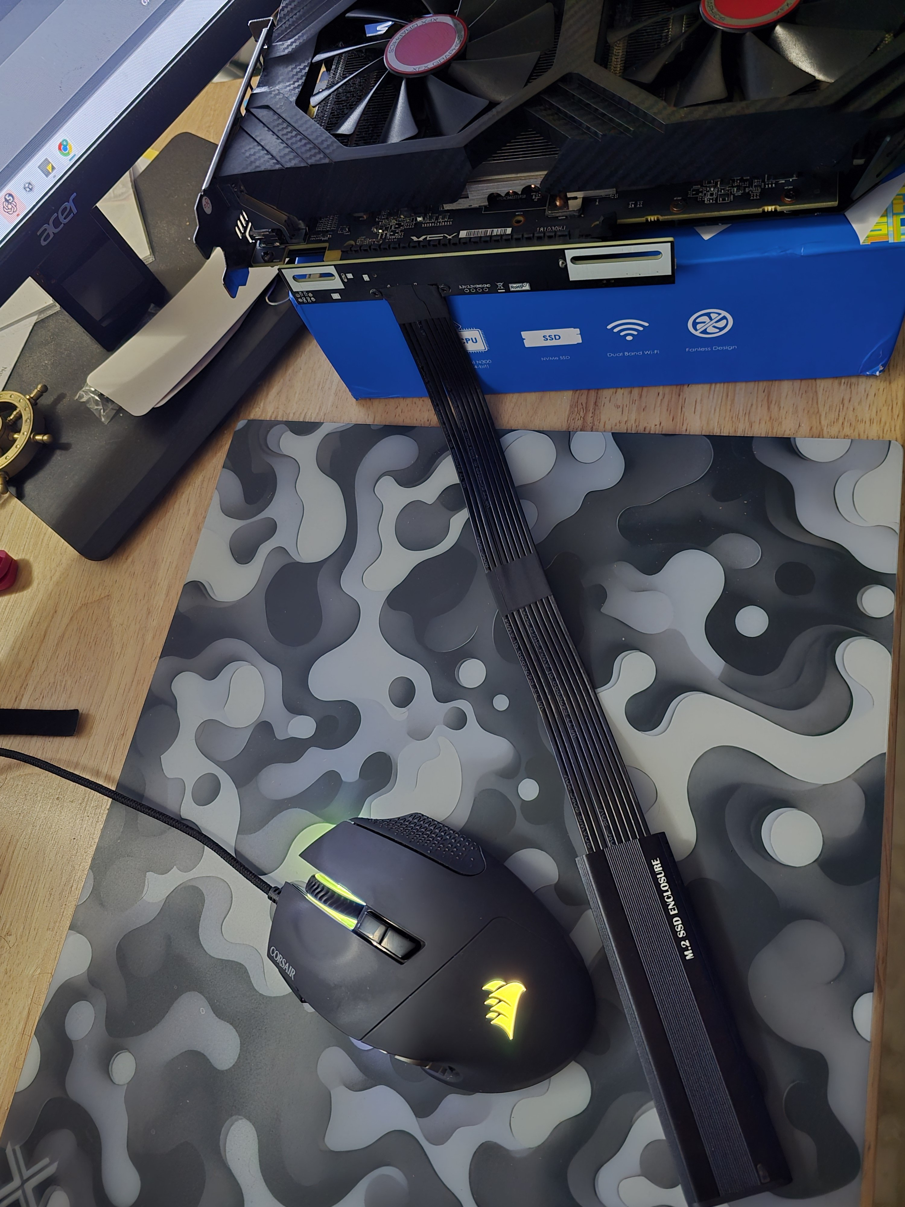 The actual RX580toUSB assembly: XFX RX 580 in a riser, with its ribbon cable entering an M.2 SSD enclosure